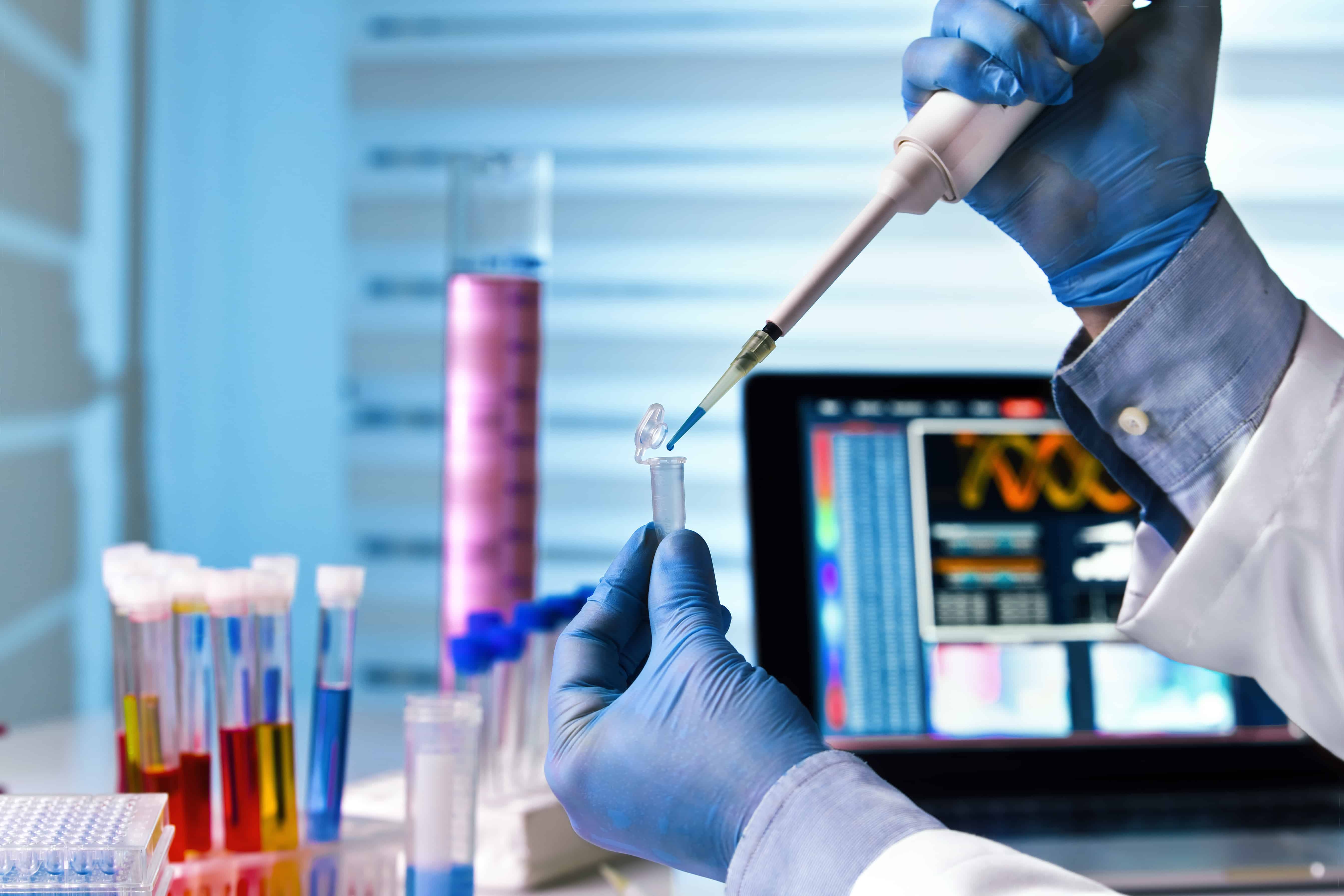 hands of engineer genetic working in laboratory / scientist holding tube and working with laptop at genetic lab autism genetics and environmental factors