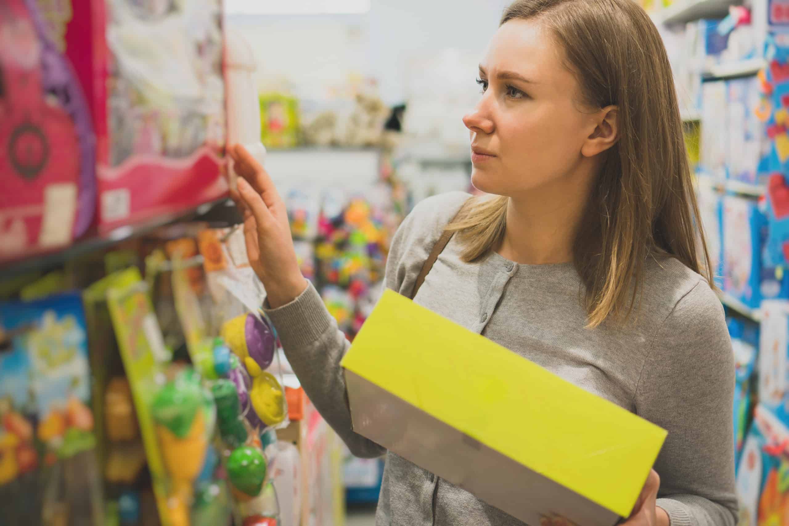 Woman choosing toy in a children’s store. autism toys