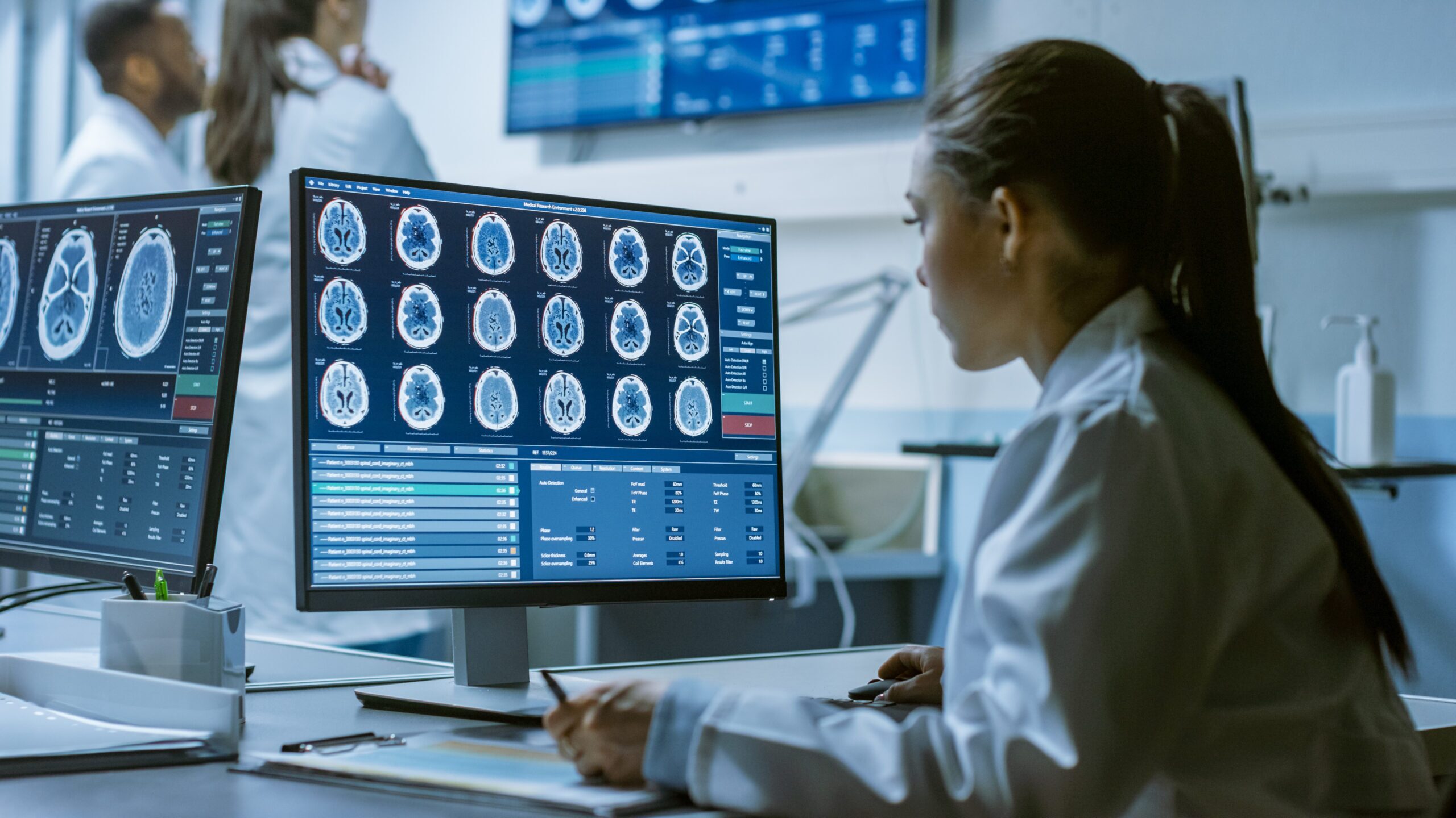 Female Medical Research Scientist Working with Brain Scans on He
