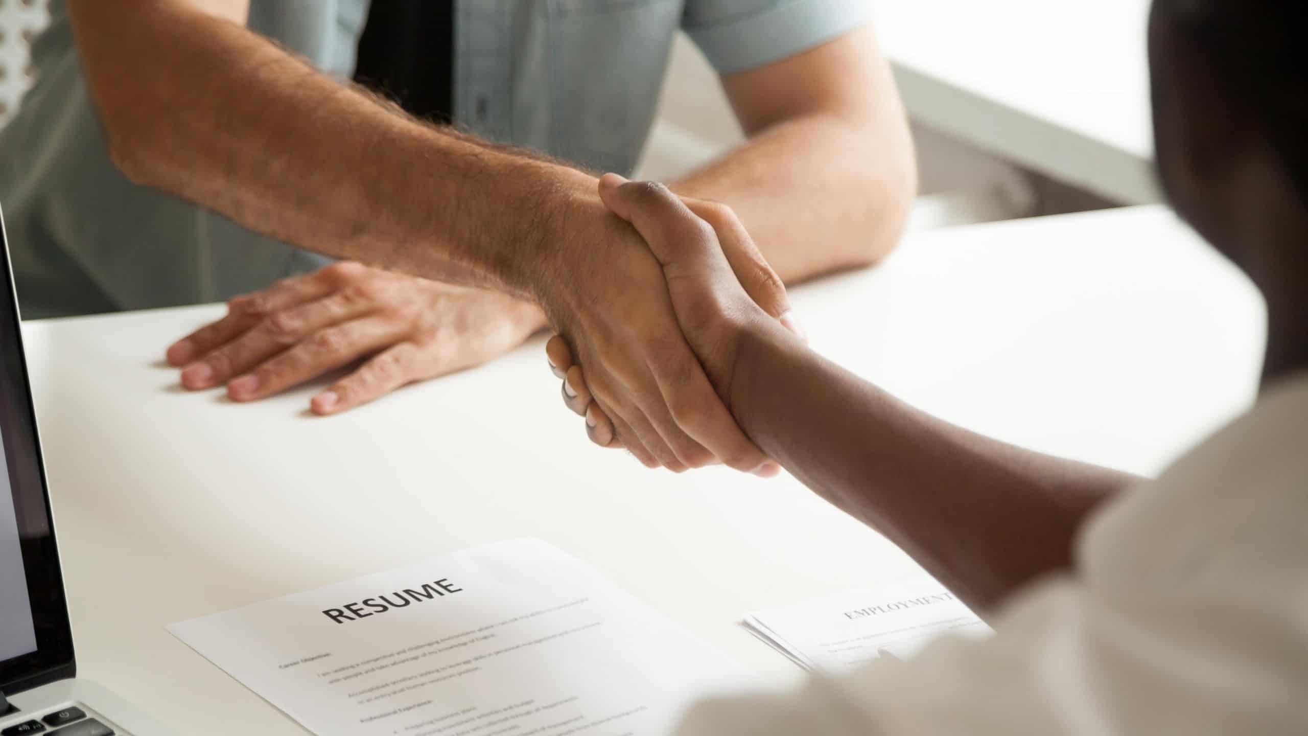 job applicant shaking hands with hiring manager autism employment, autism jobs